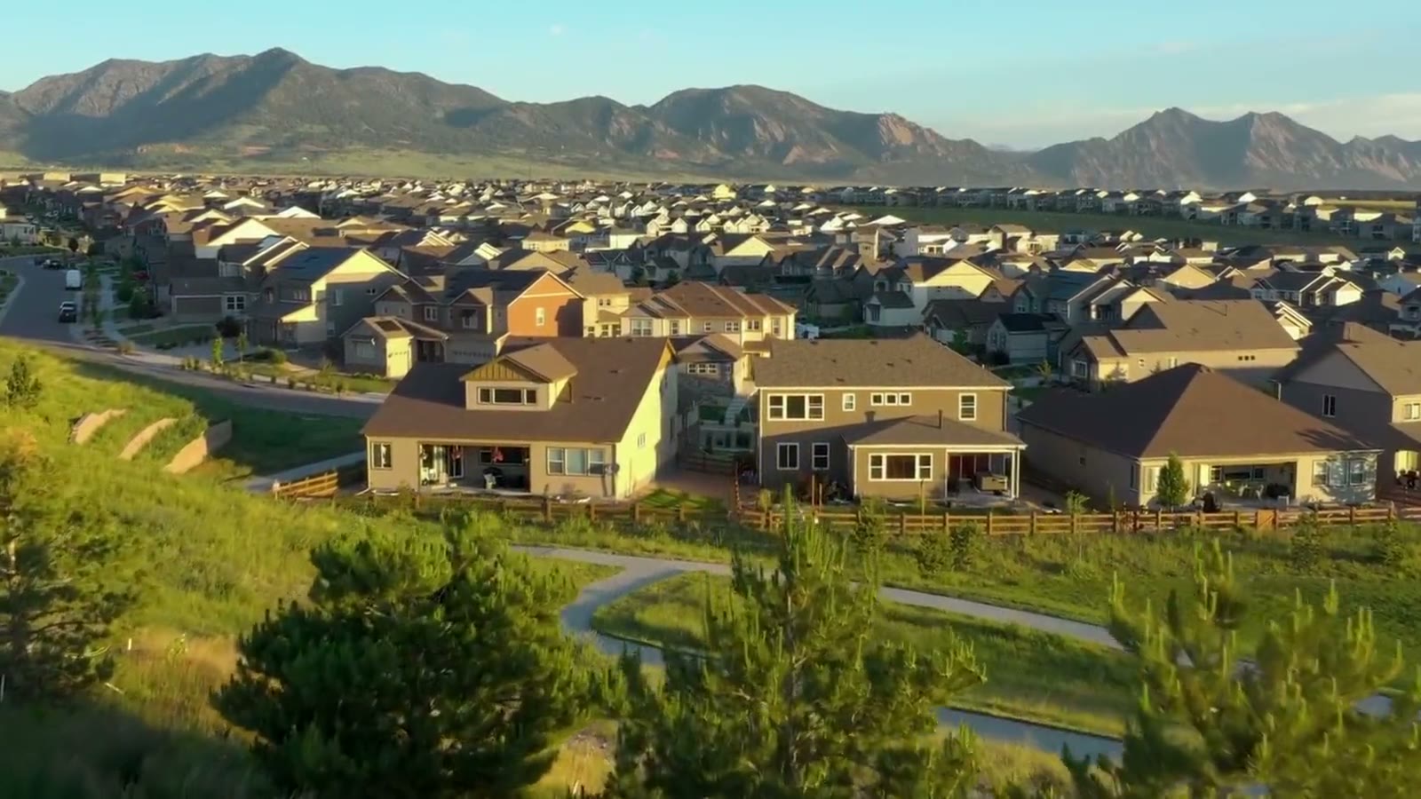 Aerial view of a Front Range neighborhood with the snow-capped foothills beyond
